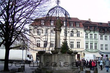 Gründungsbrunnen vor der Nikolaikirche im Nikolaiviertel in Berlin. Touristen bekommen gerade von einem Berliner erklärt, was es mit dem Brunnen auf sich hat.